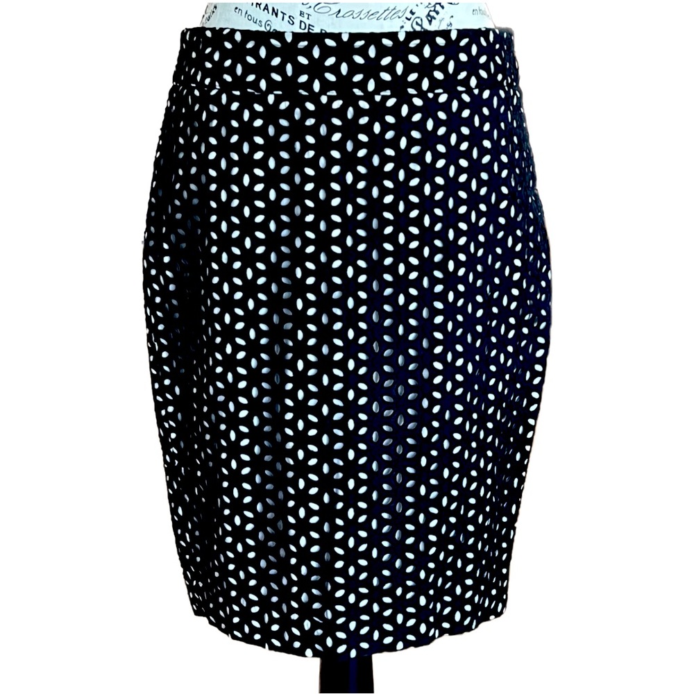 Black skirt with eyelets, blush lining. Straight, knee length.